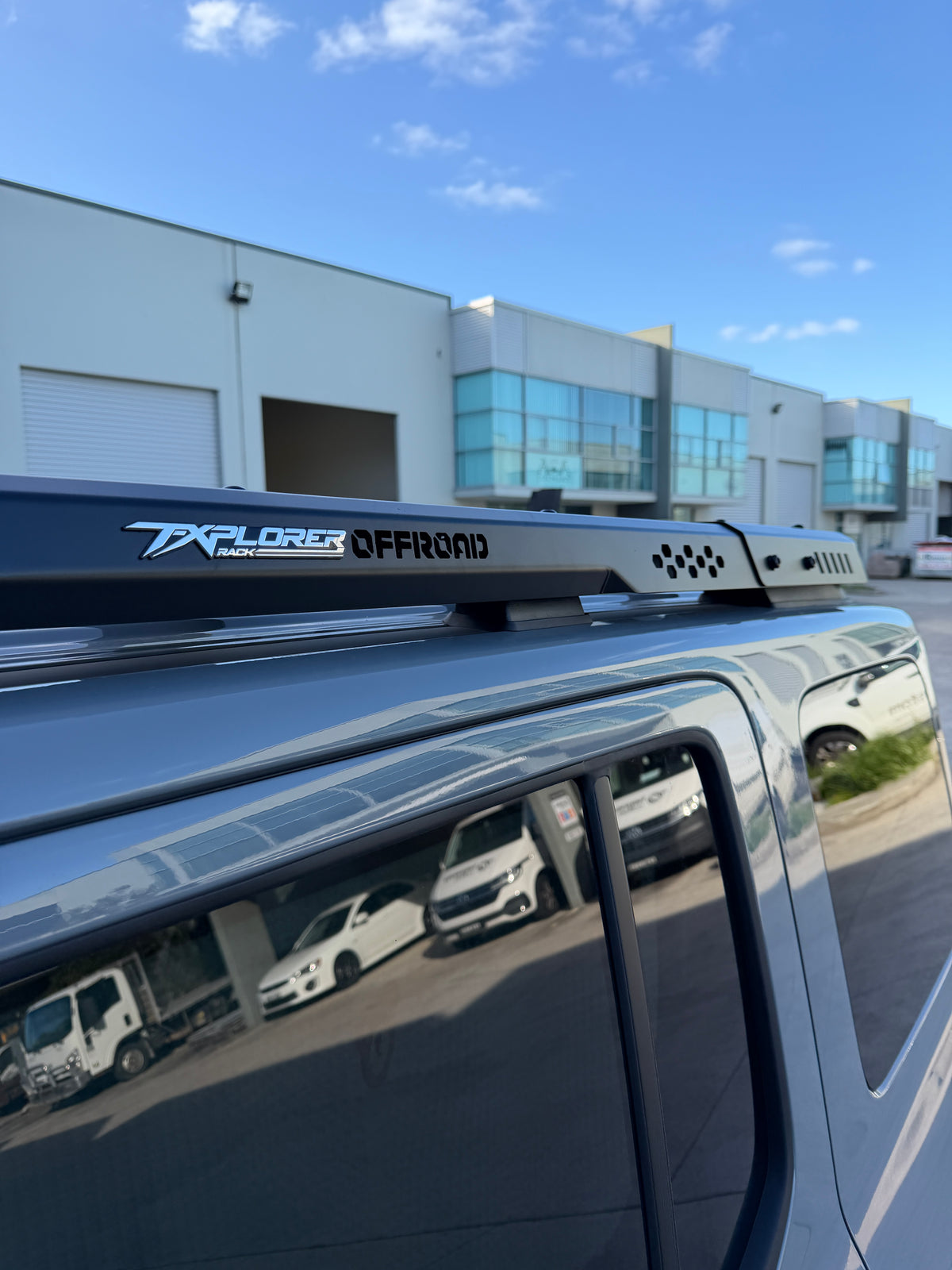 Side-on close-up of the MK Optimus roof rack rails on the roof of a white GWM Tank 300