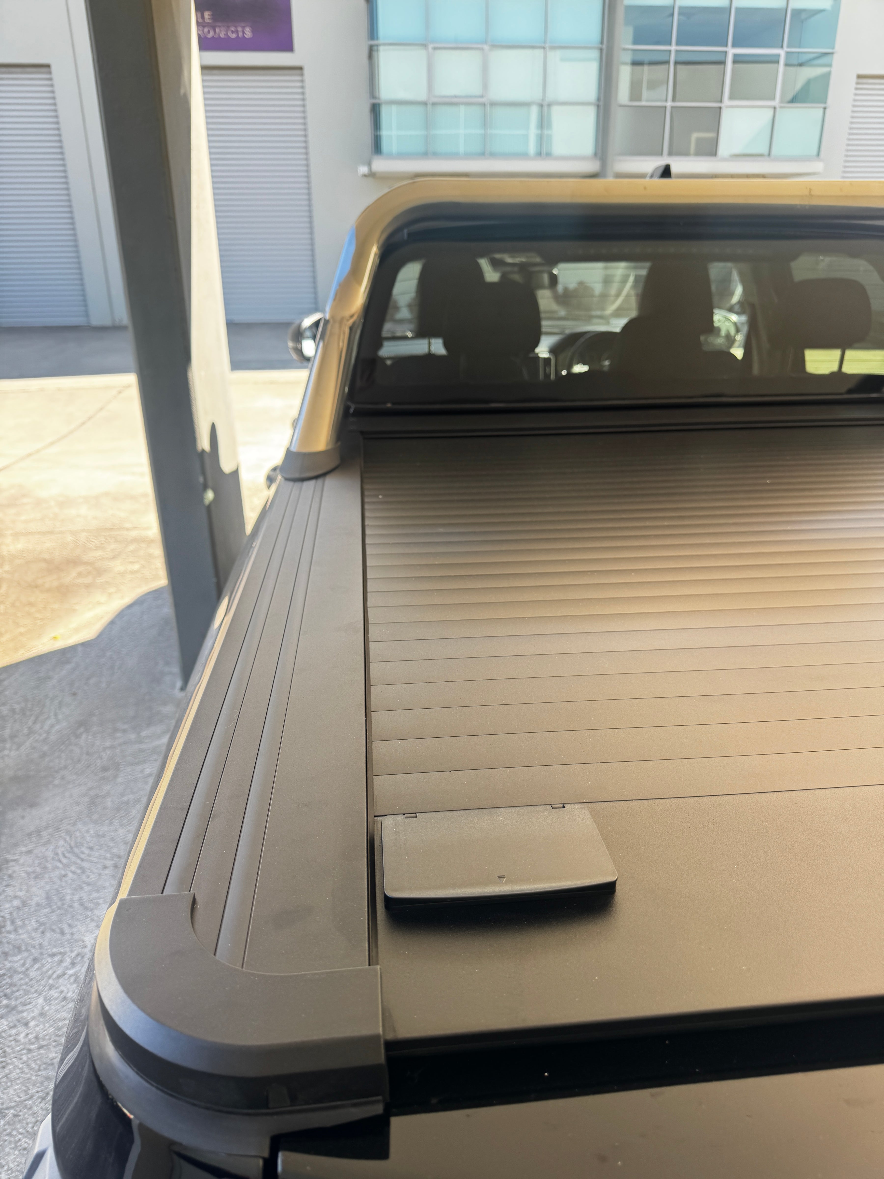 Aluminium retractable roller shutter to suit GWM Cannon 2019-2026, showing slats and side rails on the ute tub