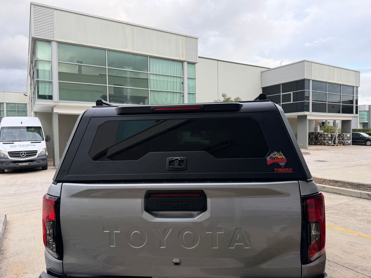 Rear view of Toyota Hilux canopy with lift-up door and EVA glass window