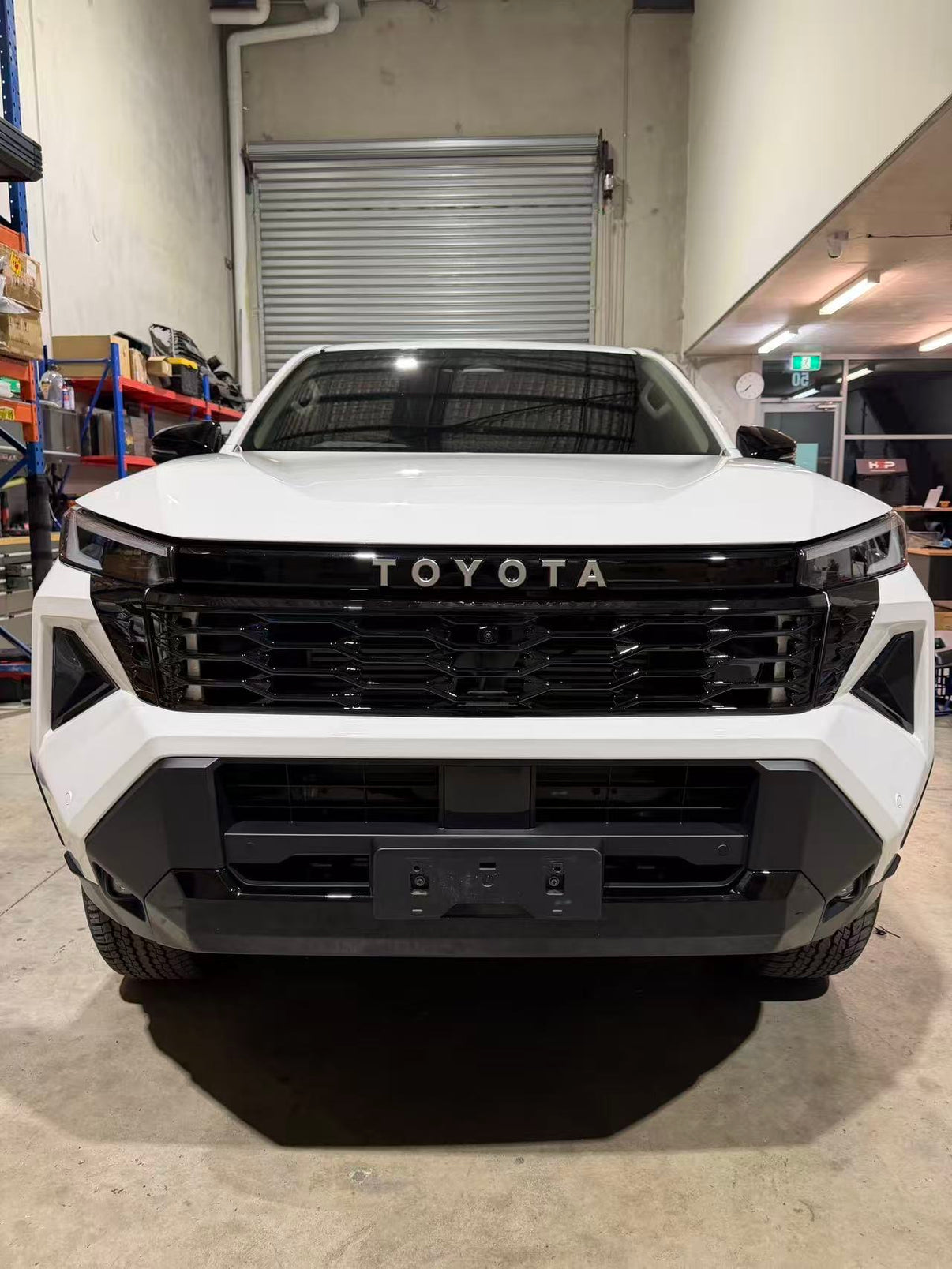 Gloss black front grille product shot with mounting hardware included