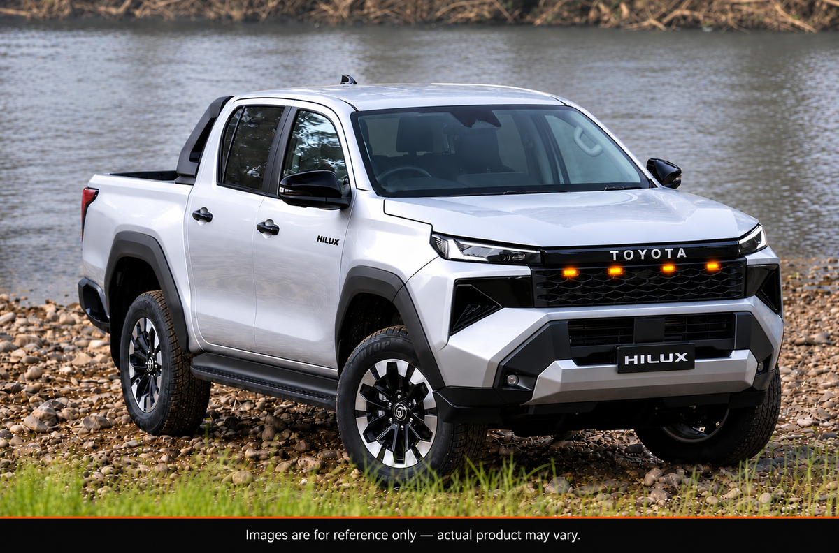 Toyota HiLux 2026 N90 with aftermarket gloss black LED grille, side angle view by the river