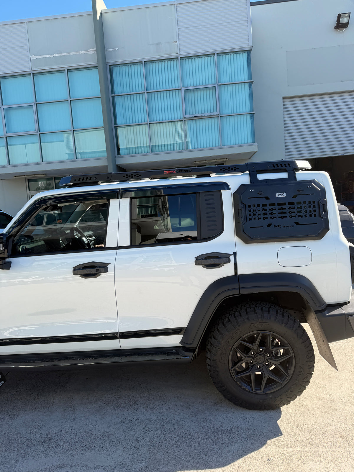 MK Optimus roof rack fitted to a white GWM Tank 300 outside the TIGER-X workshop