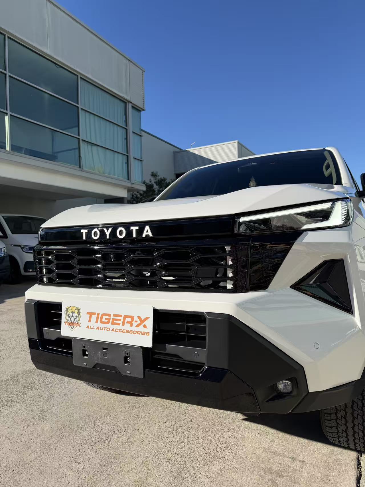 Gloss black HiLux 2026 grille showing the front camera aperture