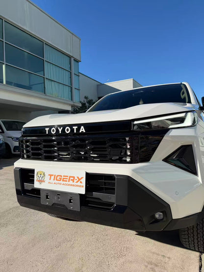 Gloss black HiLux 2026 grille showing the front camera aperture